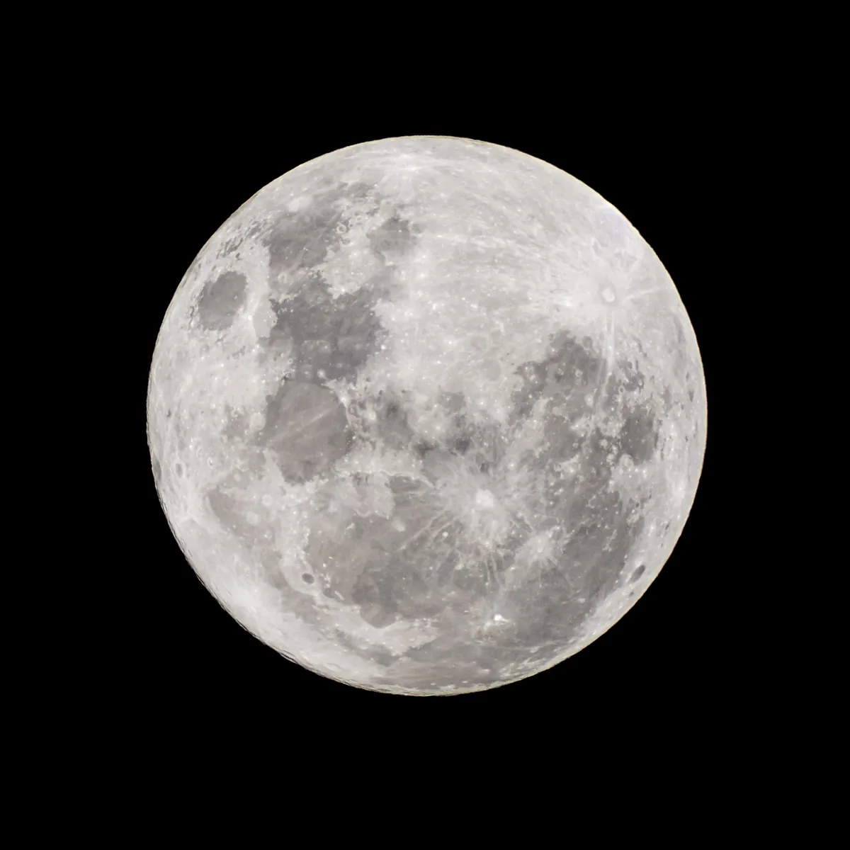The full moon, bright and sharp against a black sky