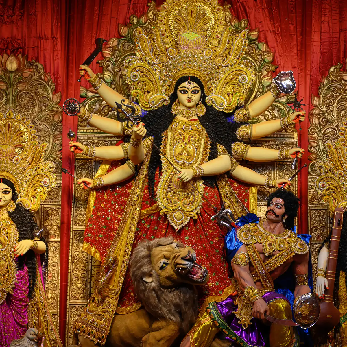 The ten-armed Devi with her lion and the demon Mahishasura, in a decorated pandal